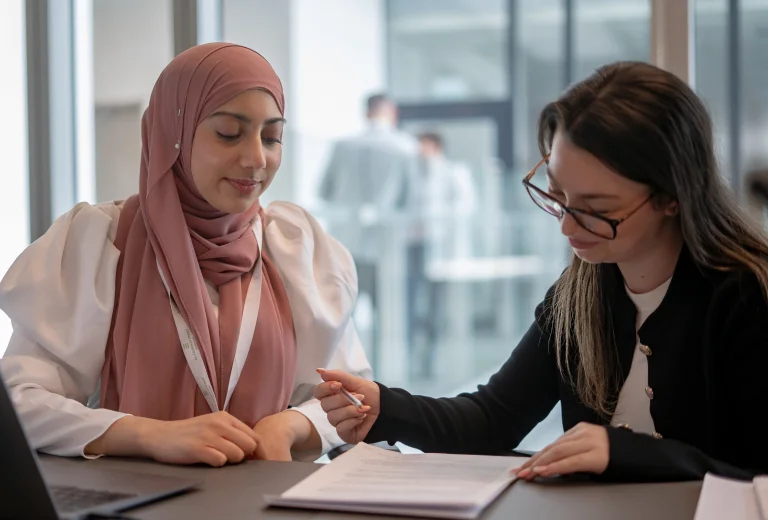 Two female Wealth Recovery Expert solicitors working together on document